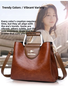 Detail of caramel PU leather tote with silver U-shaped handle and metal kangaroo emblem