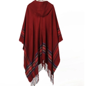 Women's red hooded poncho with colorful striped patterns and fringed tassels on the back