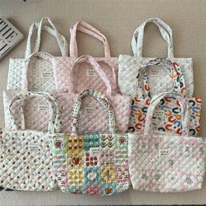 Flat lay view of various quilted cotton tote bags with floral and pattern prints