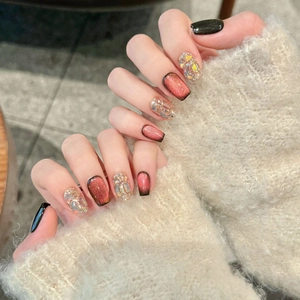 Three-tone gradient cat eye press-on nails with glitter and rhinestones on soft background