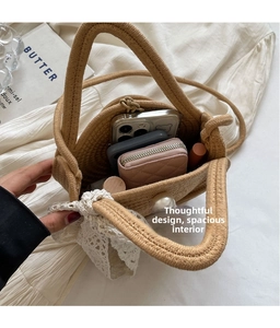 Detail of hand-woven straw bucket bag with large pearl clasp and white lace bow decoration