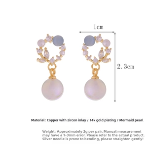 Detailed view of 14K gold plated earrings with mermaid pearls and zircon accents