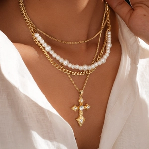 Elegant gold-tone multi-layer necklace with faux pearls and a rhinestone cross pendant