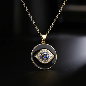 18K gold plated evil eye necklace with blue zircons on a dark background