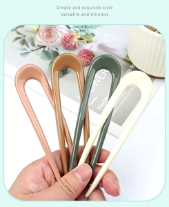 Close-up of Morandi colored U-shaped hair pins in resin for elegant bun hairstyles