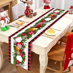 Detailed Christmas table runner with pine branches, festive bells, and red-black plaid borders