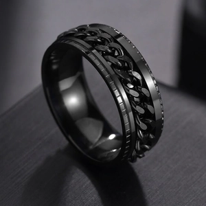Macro shot of men's black stainless steel ring with spinning chain and textured edges