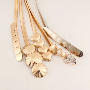 Detail view of various gold and silver elastic metal belts with assorted buckle shapes