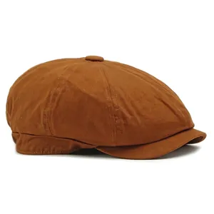 Classic brown cotton newsboy cap with octagonal crown and structured brim on white background
