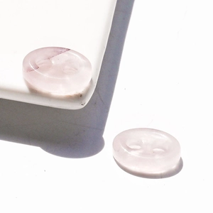 Detailed view of translucent pink quartz-style resin buckle links for DIY jewelry making