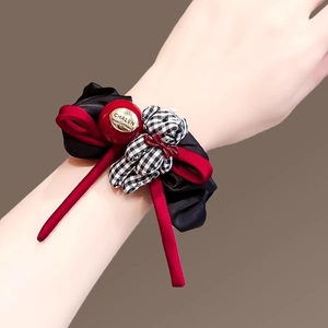 French style red and black checkered bear hair scrunchie shown worn on a wrist