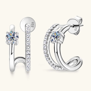 Detailed macro view of S925 sterling silver C-shaped earrings with double-row sparkling stones