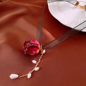 Vintage French choker with red rose pendant, black lace ribbon, and pearl tassels