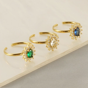 Three adjustable sunflower rings in gold with green, white, and blue oval stones