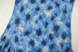 Close-up of blue and white tie-dye chiffon fabric with ruffled edge details