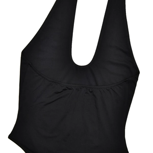 Detailed close-up of the black halter neck bodice with gathered pleats and stretchy fabric