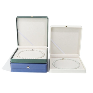 Premium crown velvet jewelry boxes in dark green, blue, and cream for pearl necklaces