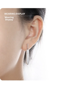 Wearing display of geometric sword-shaped S925 silver earrings with sparkling zircon