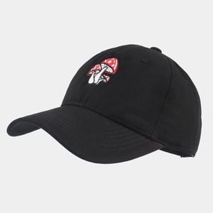 Detailed view of red and white mushroom embroidery on a black cotton baseball cap