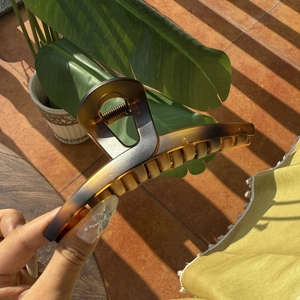 Detail of a large 13.5cm butterfly hair claw clip with amber tortoiseshell texture
