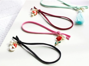 Christmas themed elastic hair ties with festive alloy charms and decorative pearls
