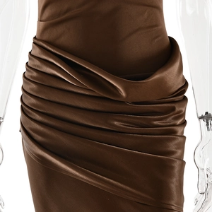 Detail of the brown satin dress waist featuring elegant pleats and draped fabric texture