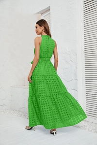 Detail of light green checkered maxi dress with tiered ruffle hem and halter neckline