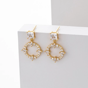 Detailed close-up of S925 sterling silver gold earrings with clear zircon stones