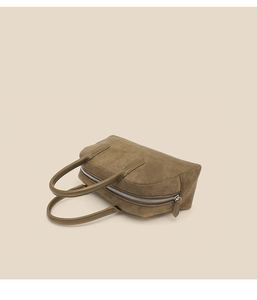 Close-up of olive green suede bowling bag showing premium leather handles and metal zipper
