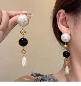 Detailed view of layered 18k gold plated pearl tassel earrings with waterdrop pendant