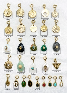 Macro display of vintage gold stainless steel charms with natural stone inlays and sizes