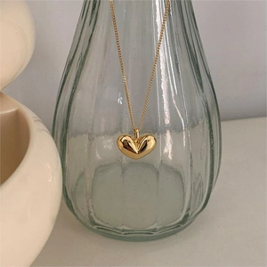 Elegant gold heart pendant necklace with minimalist mirror-polished finish for women