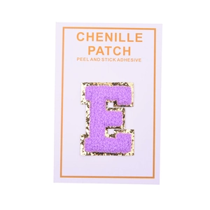 Detail of purple chenille letter E patch with gold glitter edge and peel and stick back