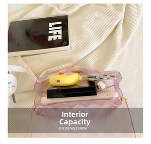 Detail view of purple transparent jelly crossbody bag showing interior storage capacity