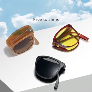 Foldable anti-UV sunglasses for women in amber, black, and red colors with a clear sky backdrop