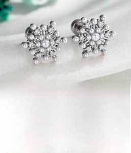 Macro shot of a snowflake cartilage stud earring with cubic zirconia and pearls