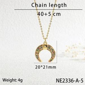 Detailed view of a gold horn pendant with multicolored cubic zirconia and size dimensions