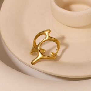 Modern minimalist irregular geometric hollow gold ring on ceramic display tray