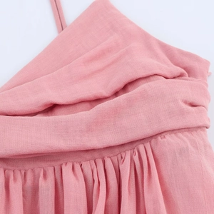 Pink midi dress showing shoulder strap detail and breathable cotton linen texture