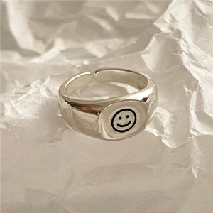 Minimalist S925 sterling silver open ring with black smiley face design on textured surface