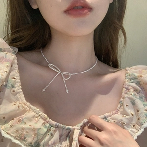 Elegant pearl choker necklace featuring a sweet bow pendant for a minimalist chic look