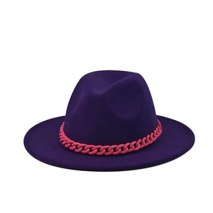Close-up of a wide brim purple felt fedora hat with a bold pink plastic chain detail