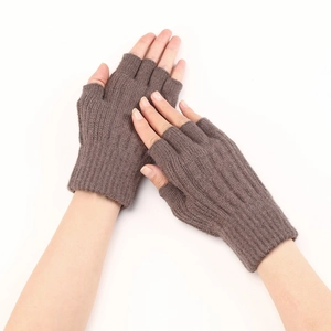 Close-up of brown cable knit fingerless gloves with ribbed cuffs on hands