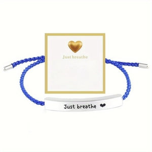 Detail of blue woven bracelet with engraved silver metal bar and inspirational gift card