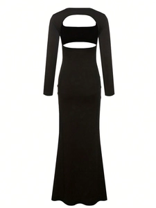 Detail of a black maternity gown with an open back and cutout design for photo shoots