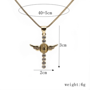 Detail of gold cross pendant with micro-set cubic zirconia and angel wings design