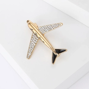Detailed view of airplane brooch with rhinestones and Love You Forever engraving