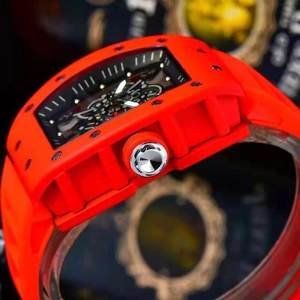 Detailed side view of the red tonneau-shaped watch case and skeletal black dial