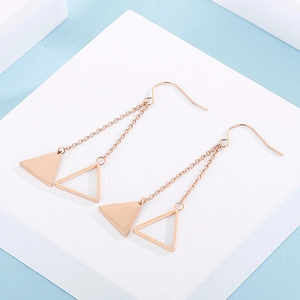 Macro shot of rose gold geometric long tassel earrings with hollow triangle charms