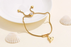 Detail of gold heart pendant and adjustable sliding clasp with micro-diamonds on box chain